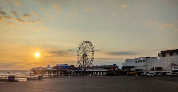 istock Beach front Silhouettes As The Sun Goes Down On A Summer's Evening 2188103604