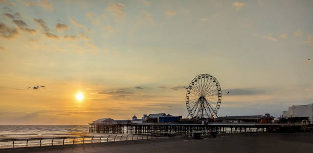istock Beach front Silhouettes As The Sun Goes Down On A Summer's Evening 2188104119