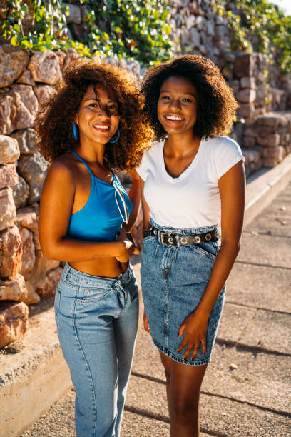 istock Two young women smiling and posing outdoors in urban setting 2188104198