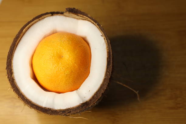 A Unique Fantasy of an Orange Displayed Inside a Coconut Shell An Artistic Still Life