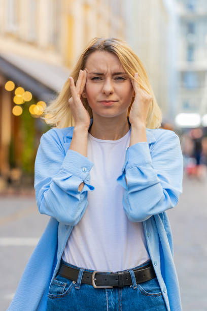 istock Displeased exhausted woman rubbing temples to cure headache problem suffering from tension migraine 2188112971