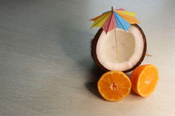 istock This is a refreshing Tropical Coconut drink garnished with a colorful umbrella and fresh oranges 2188115163