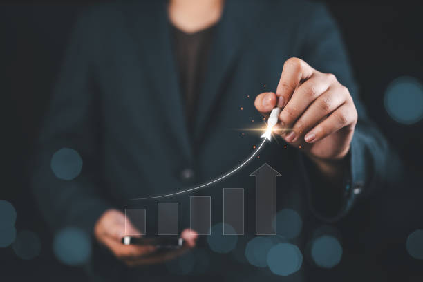 istock Strategic planner, Analyst, Investor, or Trader analyzing data to increase profits and company growth. Hand with many increasing bar graph charts for stock investments. Business strategy concept. 2188124553
