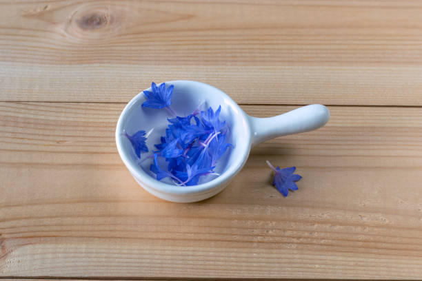 Raw cornflower petals used as dessert decoration ingredient. Sauce boat in shape of frying pan.