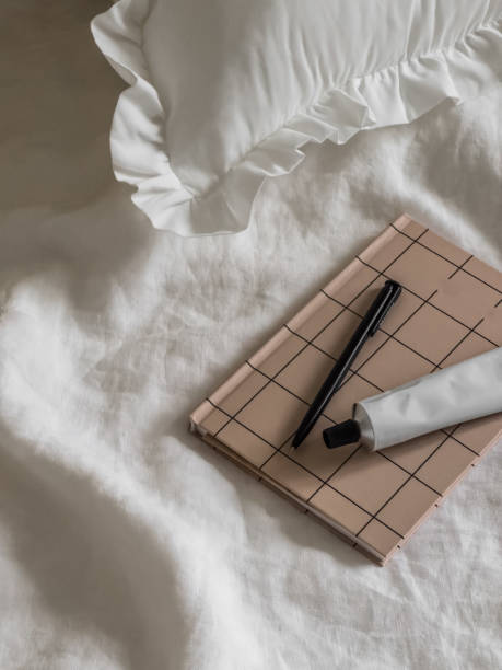 istock Cozy white bed, notepad, cream. A lazy, comfortable morning 2188126132