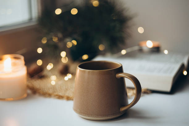 istock Christmas cozy home background with candle and cup on windowsill, copy space. 2188126246