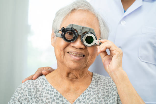 istock Asian senior woman wearing ophthalmic vision eye test and using optical trial frame. 2188127612
