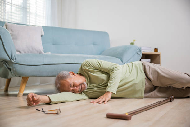 istock Asian old man lying on floor after falling down with wooden walking stick 2188128414