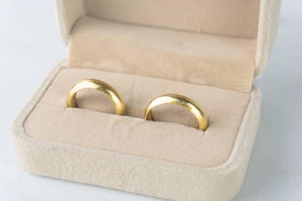 istock Two gold wedding in ring box against a white background. 2188132596