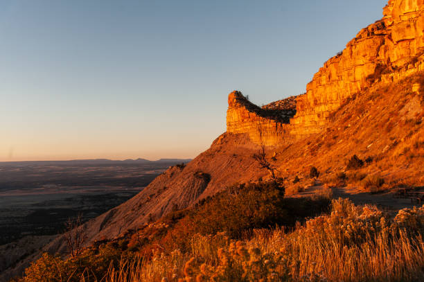 istock Golden hour light over a rocky cliff with vast plains below 2188133746