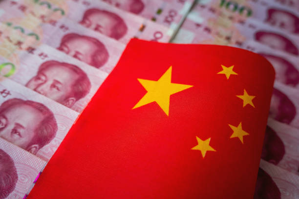 istock Interest rate cut concept illustration. Banknotes and flags were exposed multiple times. Close-up of Chinese flag and Chinese yuan combined. inflation. 2188133795