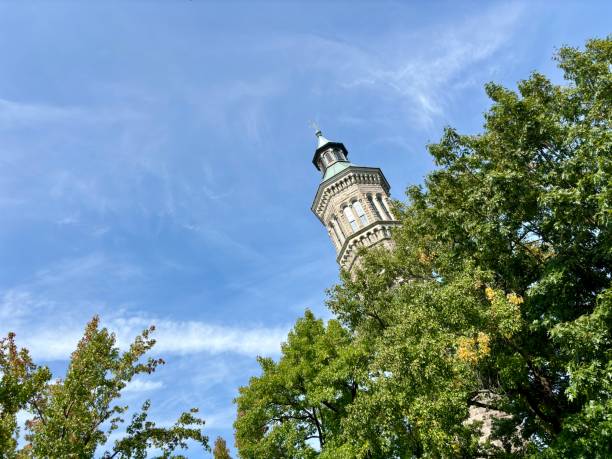 Historic Highbridge Water Tower behind trees under blue sky in New York, New York, United States