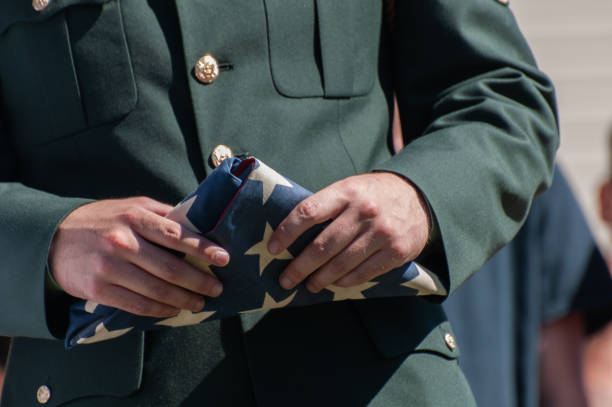 istock Military officer holding a folded American flag during a ceremon 2188134027
