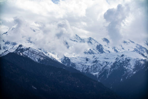 istock A beautiful snowy mountain range with a cloudy sky looming overhead 2188137557