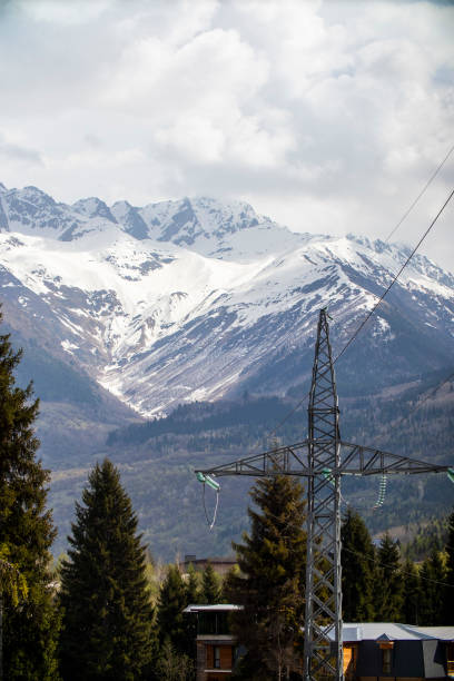 istock A power line is in the foreground, with a snowy mountain behind 2188138478