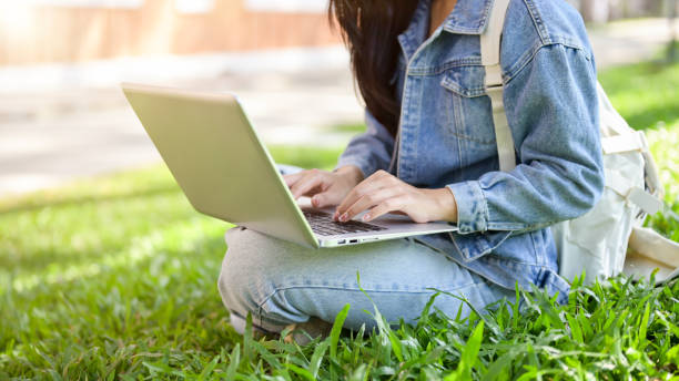 istock A cropped image of a female student sitting on the grass in her university park, using her laptop. 2188142308
