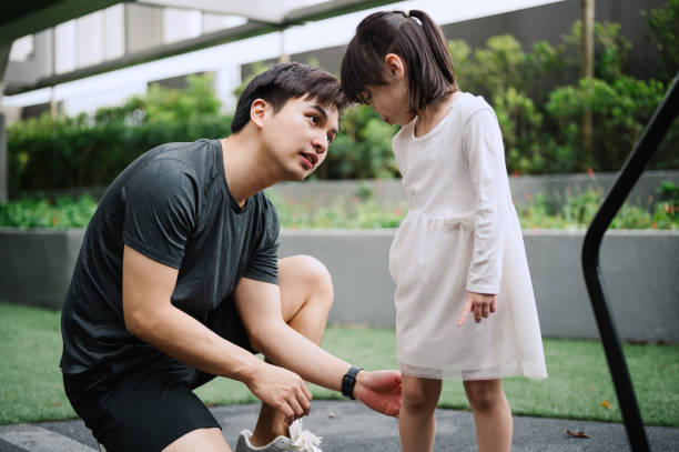 istock Asian father playing with his daughter at public park 2188142792