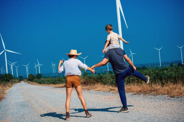 istock Father carrying son on shoulders in wind turbine 2188142905