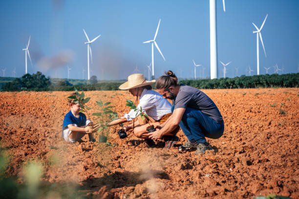 istock Little boy planting trees with her mother and father 2188142964