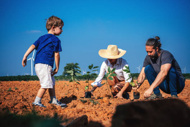 istock Family planting trees together 2188142974