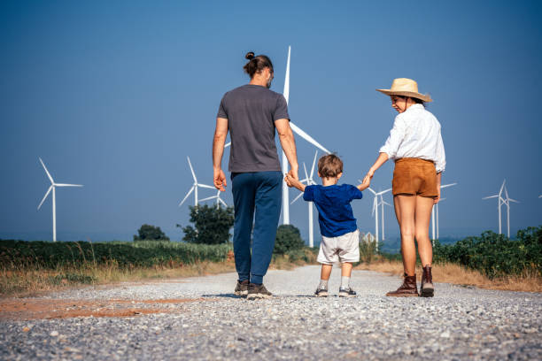 istock Parents, back and holding hands with child in field 2188142988