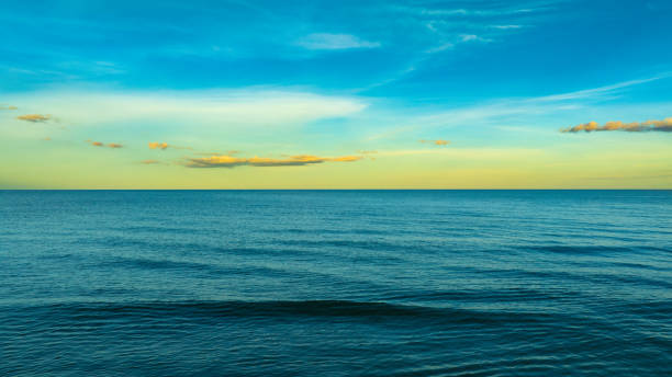 istock Panoramic skyline view The sun sets in the evening sky with colorful clouds. and beautiful cloud patterns In the soft light Evening at the sea 2188145919