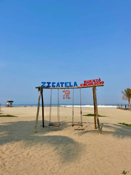 istock Sandy swings at Playa Zicatela under a clear Puerto Escondido sky 2188151011
