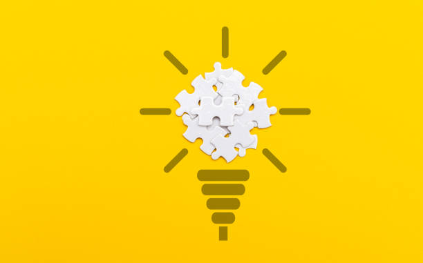 istock Top view of light bulb from puzzles on yellow background 2188151330
