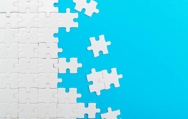 istock Incomplete white puzzle pieces on blue background 2188151346