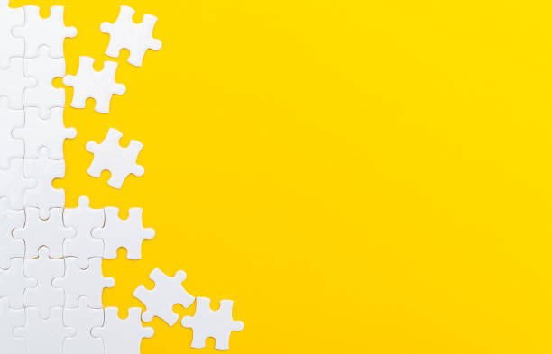 istock Incomplete white puzzle pieces on yellow background 2188151348