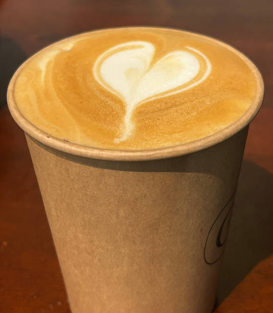 istock Takeaway cappuccino with latte art heart in cardboard cup 2188151361