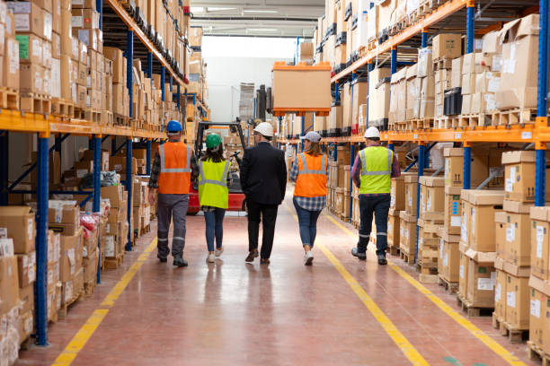 istock Collaborative Innovation: Brainstorming and Discussion in Factory Warehouse Corridor 2188152078