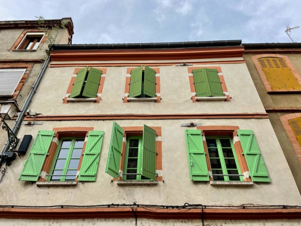 istock Charming Toulouse facade with vibrant green shutters and rustic architecture 2188154121