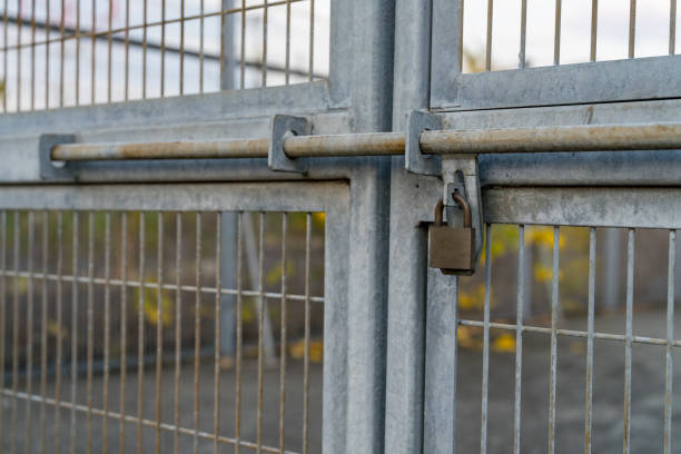 padlock attached to rusted fence