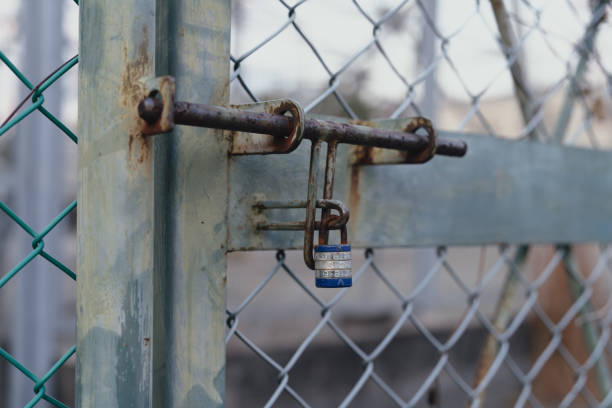 istock Combination padlock attached to rusted fence 2188155753