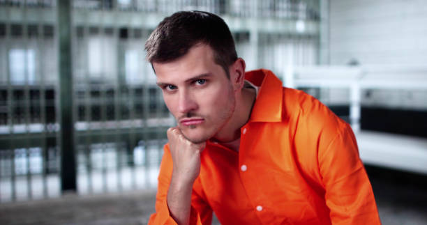 istock Prisoner Behind Bars In Jail Cell. Crime Punishment 2188158258