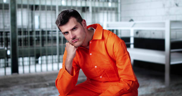 istock Prisoner Behind Bars In Jail Cell. Crime Punishment 2188158262