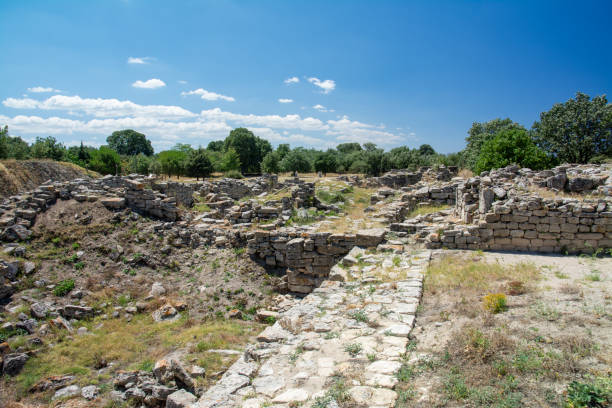 istock Ancient Stone Pathway Through Historic Troy Archaeological Site in Turkey: Preserved Limestone Walls of Legendary Trojan Civilization Under Summer Sky 2188158383