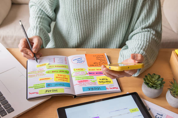 istock Entrepreneur Managing Digital Agenda With Smartphone, Scheduling Meetings, Reviewing Emails, Paying Bills, Tracking Finances, Planning Tasks, Setting Goals, And Enhancing Productivity At Home Or Work 2188159881