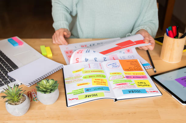 istock Efficient Woman Planning Calendar For Home Or Work, Setting Goals, Managing Events, Meetings, Budget, Productivity, Time Management, Finances, Daily Expenses, And New Beginnings Concept. 2188160008