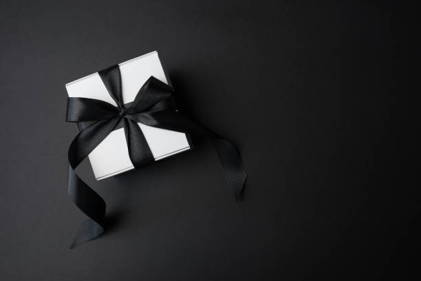 istock gift box with black bow on black background with copy space. Black Friday, banner 2188161224
