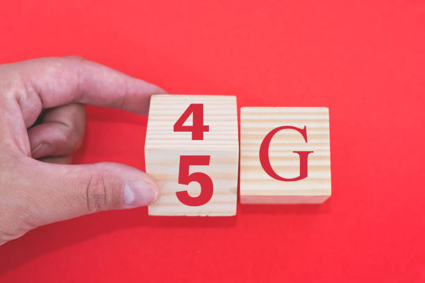 istock 5G (5th generation) network connecting future technologies around the world. Handmade rocker wooden cube change the number 4G to 5G on a red background. 2188162092