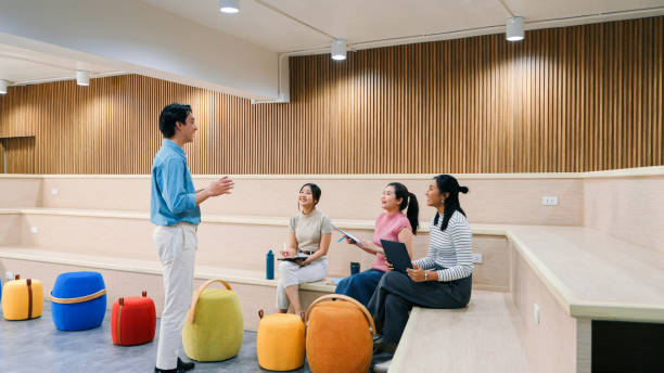istock A diverse group of professionals collaborates on a project in a spacious, modern office. Showcasing teamwork, casual interaction, and creativity in a bright workspace. 2188163057