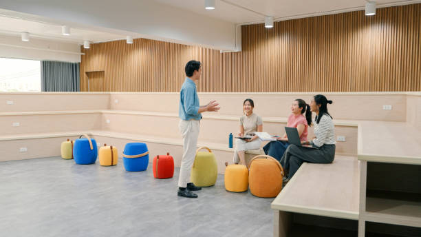 A diverse group of young professionals collaborates on a creative project in a modern workspace. Ideal for teamwork, innovation, and workplace diversity themes.