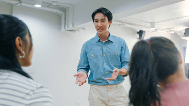 istock Confident Team Leader Presenting Ideas to Colleagues in a Modern Office Setting 2188163079