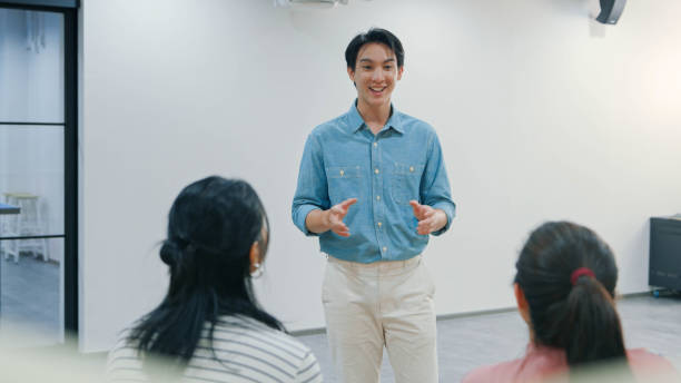 istock Young professional presenting ideas and motivating a diverse team in a casual workspace. Reflecting leadership, collaboration, and innovation in a contemporary setting. 2188163090