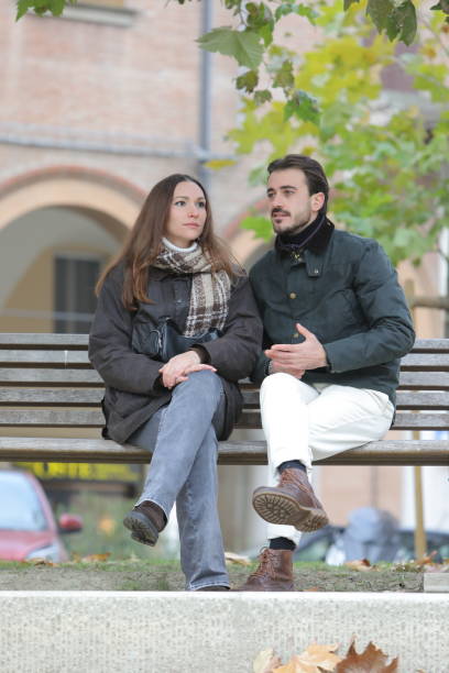 istock Young couple talking and discussing on bench in autumn 2188163621