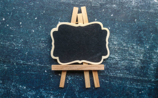 istock Wooden easel mini blackboard with faded chalk surface, isolated on gray background. Blank space for text 2188169718