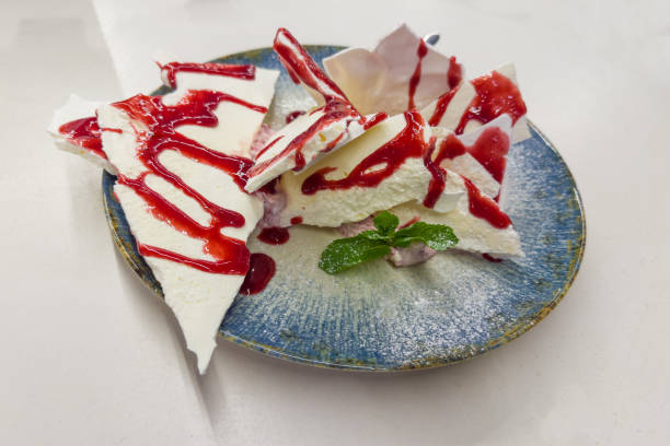 istock Dessert of meringue with mascarpone poured over with raspberry jam 2188170934