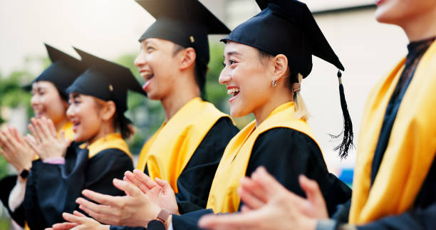 istock Asian people, success or graduates clapping with qualification at university for education scholarship. College, happy or excited students on outdoor campus with degree, milestone or diploma in Japan 2188173825